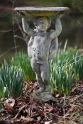 A lead figural bird bath