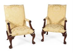 A pair of mahogany and upholstered armchairs in George III style