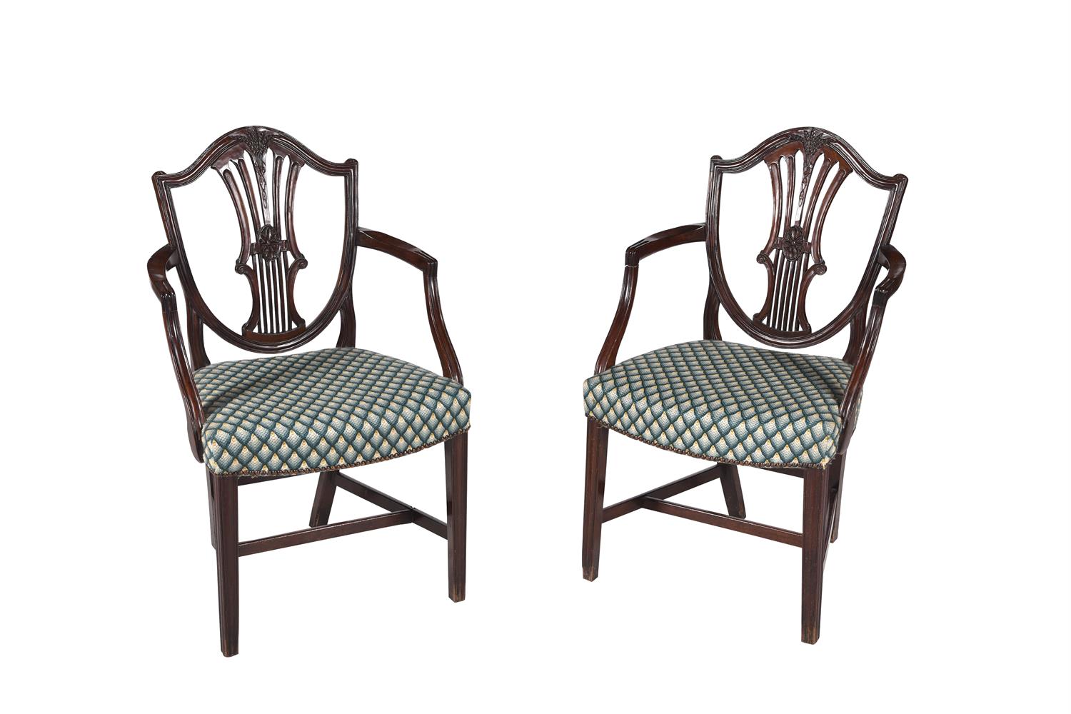 A pair of George III mahogany shield back elbow chairs