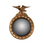 A giltwood and composition convex wall mirror in Regency style