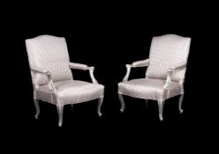 A pair of French silvered wood and upholstered open armchairs