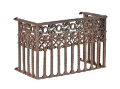 A wrought iron model of a balcony or firegrate