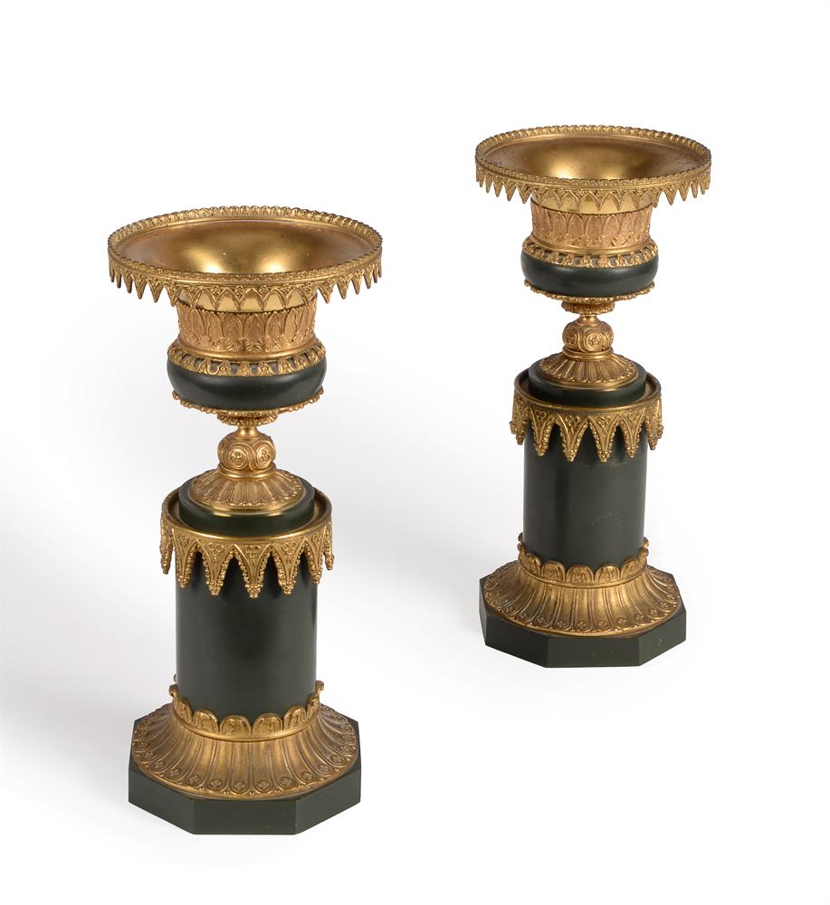 A pair of gilt and green painted metal candlesticks in Gothic taste