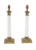 A pair of milk glass and gilt metal mounted columnar table lamps