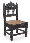 An ebonised and carved hardwood side chair