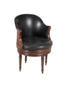 A French beech and leather upholstered revolving desk chair