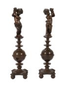 A pair of cast and patinated metal andirons