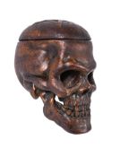 A carved giltwood and composition model of a human skull