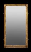 A giltwood wall mirror in Egyptian Revival taste