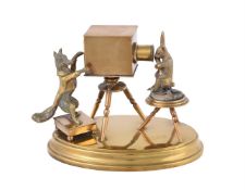 A novelty brass inkwell