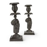 A PAIR OF PATINATED BRONZE CANDLESTICKS