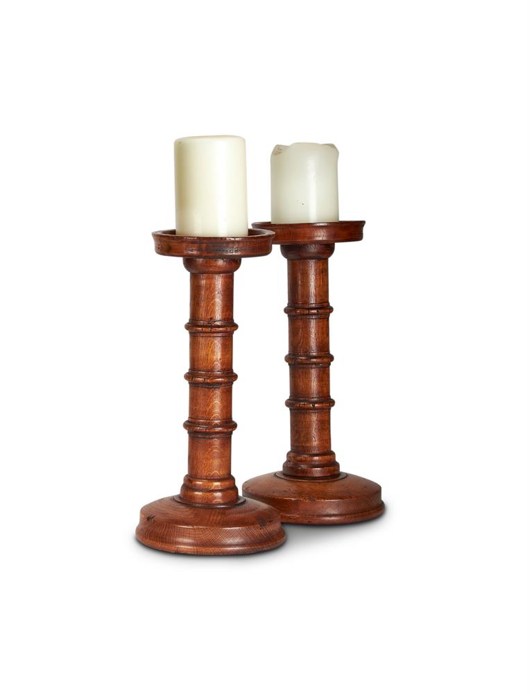 A PAIR OF TURNED AND STAINED WOOD PRICKET CANDLESTICKS