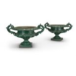 A PAIR OF VICTORIAN GREEN PAINTED CAST IRON URNS, POSSIBLY BY HANDYSIDE