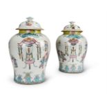 A GOOD PAIR OF CHINESE 'FAMILLE ROSE' VASES AND COVERS