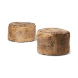 TWO SIMILAR DISTRESSED LIGHT BROWN HIDE POUFFES