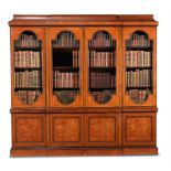 A SATINWOOD AND MAHOGANY CROSSBANDED BREAKFRONT LIBRARY BOOKCASE, IN GEORGE III STYLE