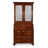 A GEORGE II MAHOGANY AND CROSSBANDED BUREAU CABINET, CIRCA 1750