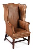 A MAHOGANY AND LEATHER UPHOLSTERED WING ARMCHAIR, CIRCA 1750 AND LATER