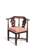 A George III mahogany and upholstered corner armchair