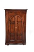 A mahogany standing corner cupboard