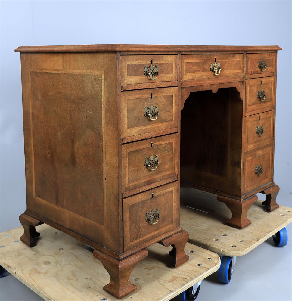 A walnut and featherbanded kneehole desk in the George II style