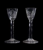 A pair of engraved facet-stemmed wine glasses