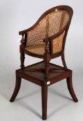 A 19th century child's mahogany bergere chair and stand