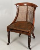 A late Regency mahogany bergère library chair