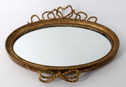 An oval gilt mirror