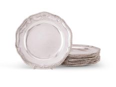 A set of twelve late George II silver shaped circular dinner plates by Edward Wakelin