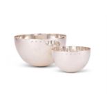 A matched pair of graduated hammered silver bowls by William & Son (William Rolls Asprey)