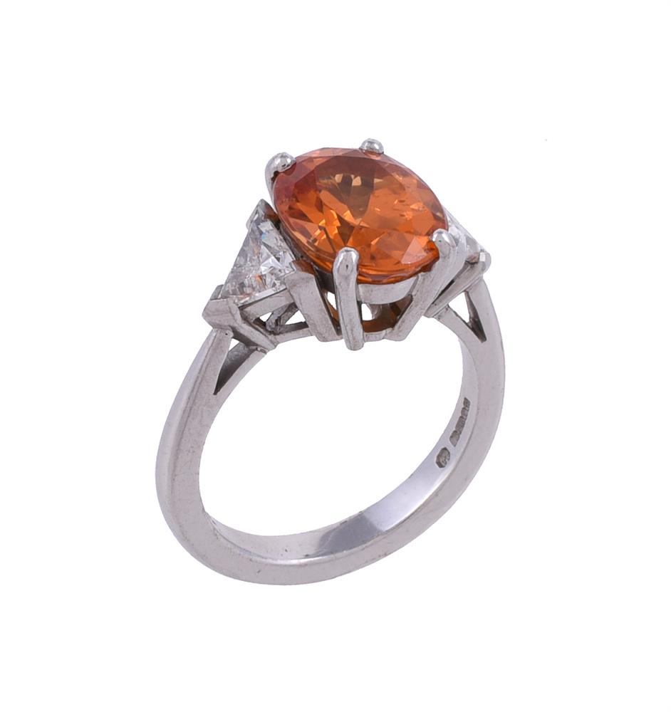 A three stone spessartine garnet and diamond ring by Theo Fennell