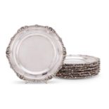 A matched set of twelve Victorian silver shaped circular dinner plates