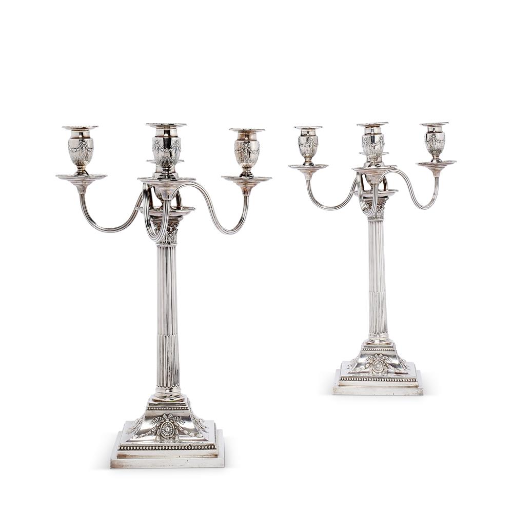 A pair of Victorian silver four light Corinthian column candelabra
