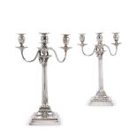 A pair of Victorian silver four light Corinthian column candelabra