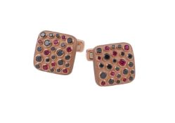 A pair of black diamond and ruby cufflinks by William & Son