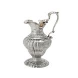 A George II silver lobed ogee baluster cream jug by Francis Crump