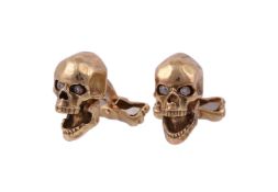A pair of diamond set skull cufflinks by Deakin & Francis