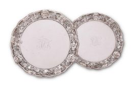 A pair of George II silver shaped circular waiters