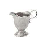 A George I cast silver helmet shaped cream jug by Pézé Pilleau