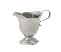 A George I cast silver helmet shaped cream jug by Pézé Pilleau
