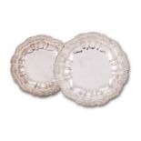 A pair of late George III silver shaped circular course dishes by Joseph Angell I