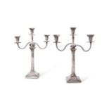 A pair of late Victorian silver three light Corinthian column candelabra