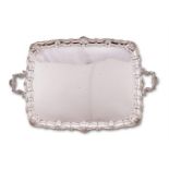 An Edwardian silver shaped rectangular twin handled tray by Wakely & Wheeler (James Wakely & Frank C