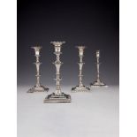 A set of four early George III cast silver square candlesticks by Ebenezer Coker