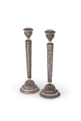 A pair of silver filigree circular candlesticks