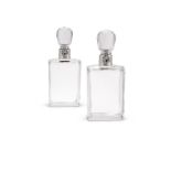 A pair of silver mounted lockable glass decanters and stoppers by Hukin & Heath Ltd