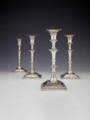 A set of four early George III cast silver square candlesticks by William Cafe