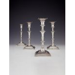 A set of four early George III cast silver square candlesticks by William Cafe