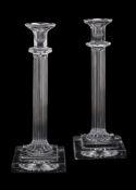 A pair of press moulded clear glass columnar candlesticks by William Yeoward